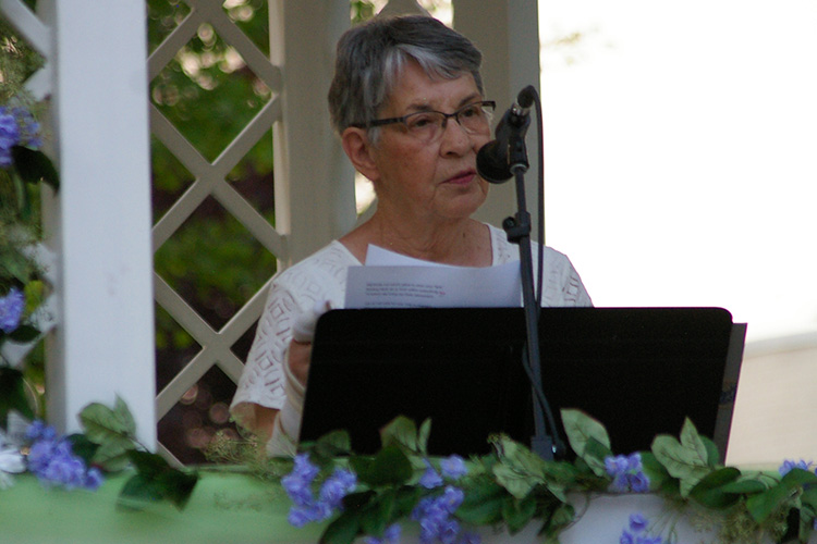 Char Halverson, Hospice of Dubuque Board Member, reads a reflection.